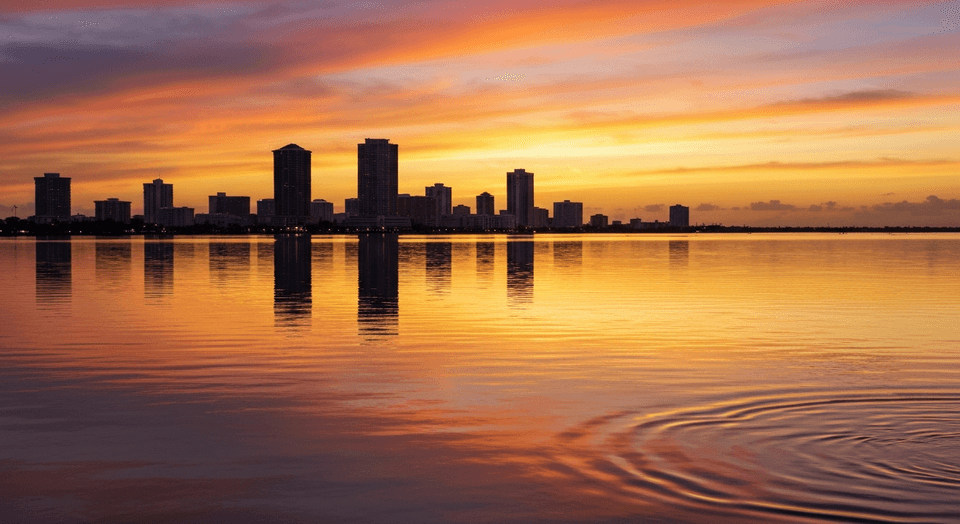Tropical cruise boat at sunset on Sarasota Bay with downtown skyline