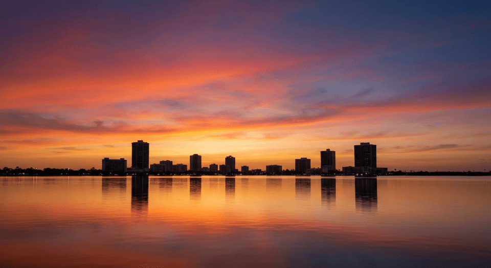 Sunset over Sarasota Bay with cruise boat and downtown skyline in the distance