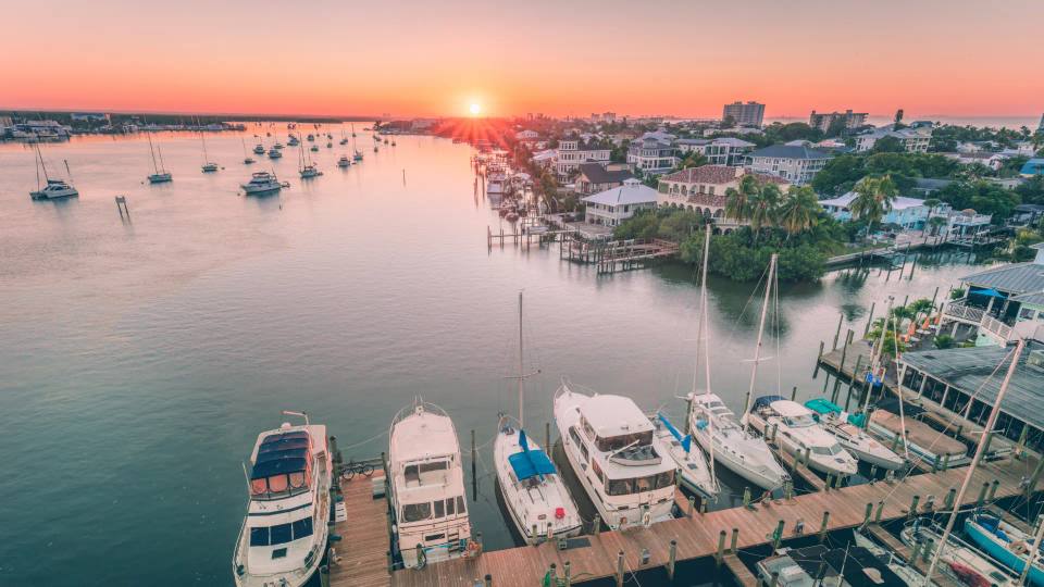 Calmer bay water and lighthouse-zone sunset colors near Fort Myers