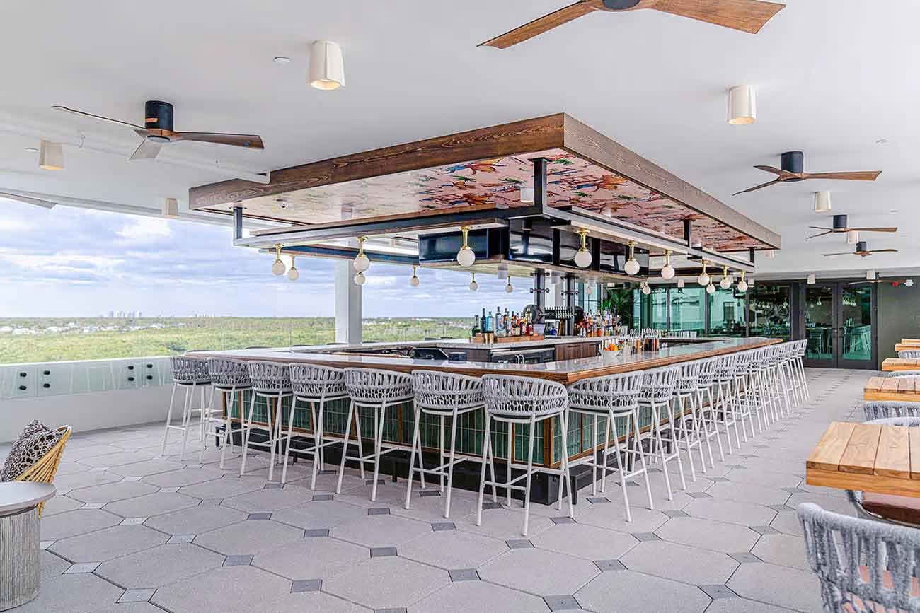 Naples Pier at sunset with beachgoers