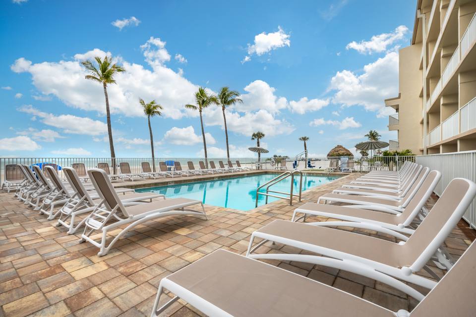 Hotel pool deck with palm trees in Estero area Florida
