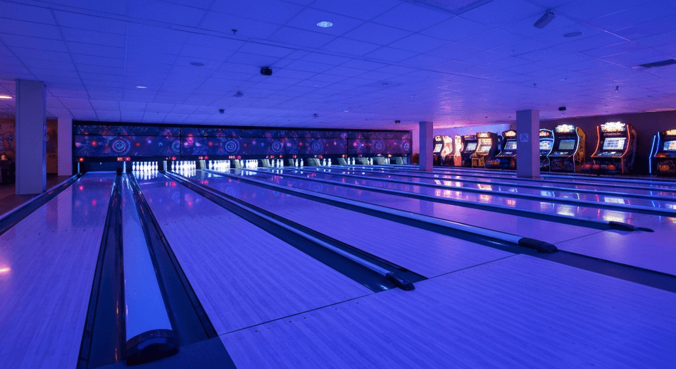 Bowling lanes lit with colorful lights at Bowlero Cape Coral